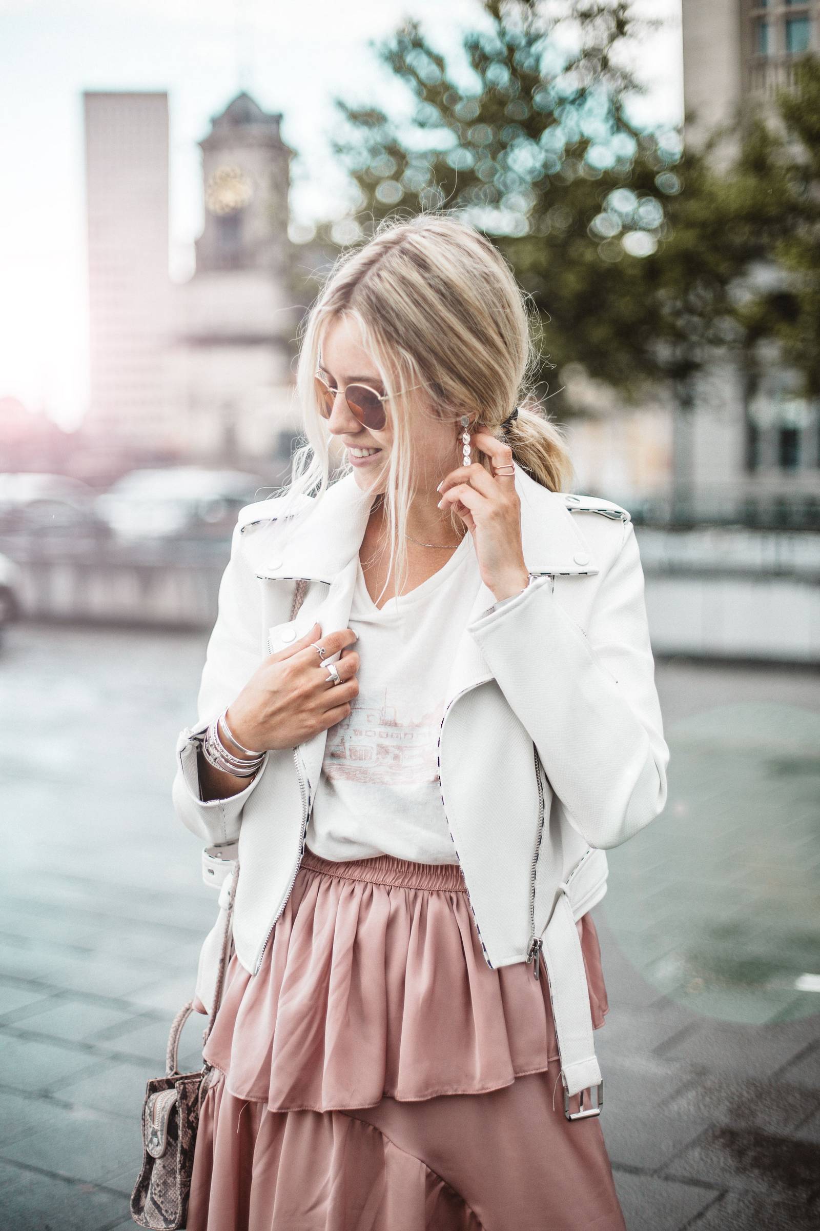Asymetric skirt and white leather jacket