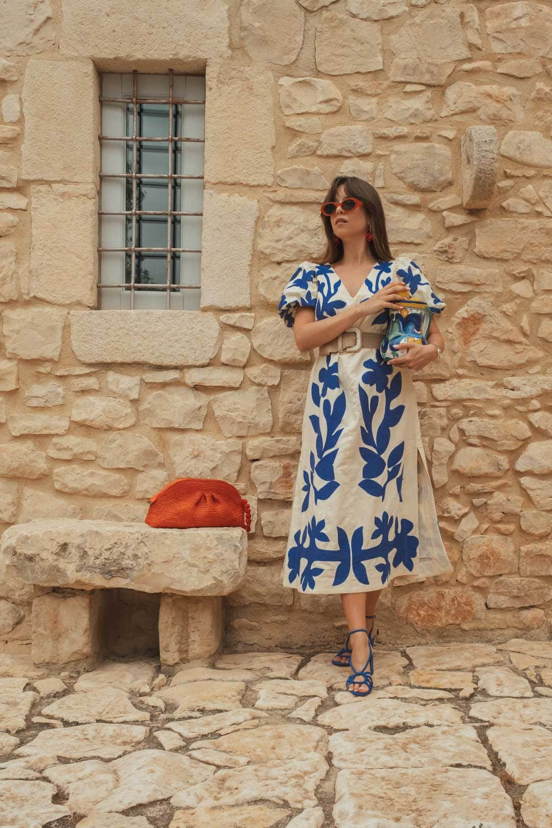 Femme tenue d'été Sézane robe blanche et bleue et accessoires oranges